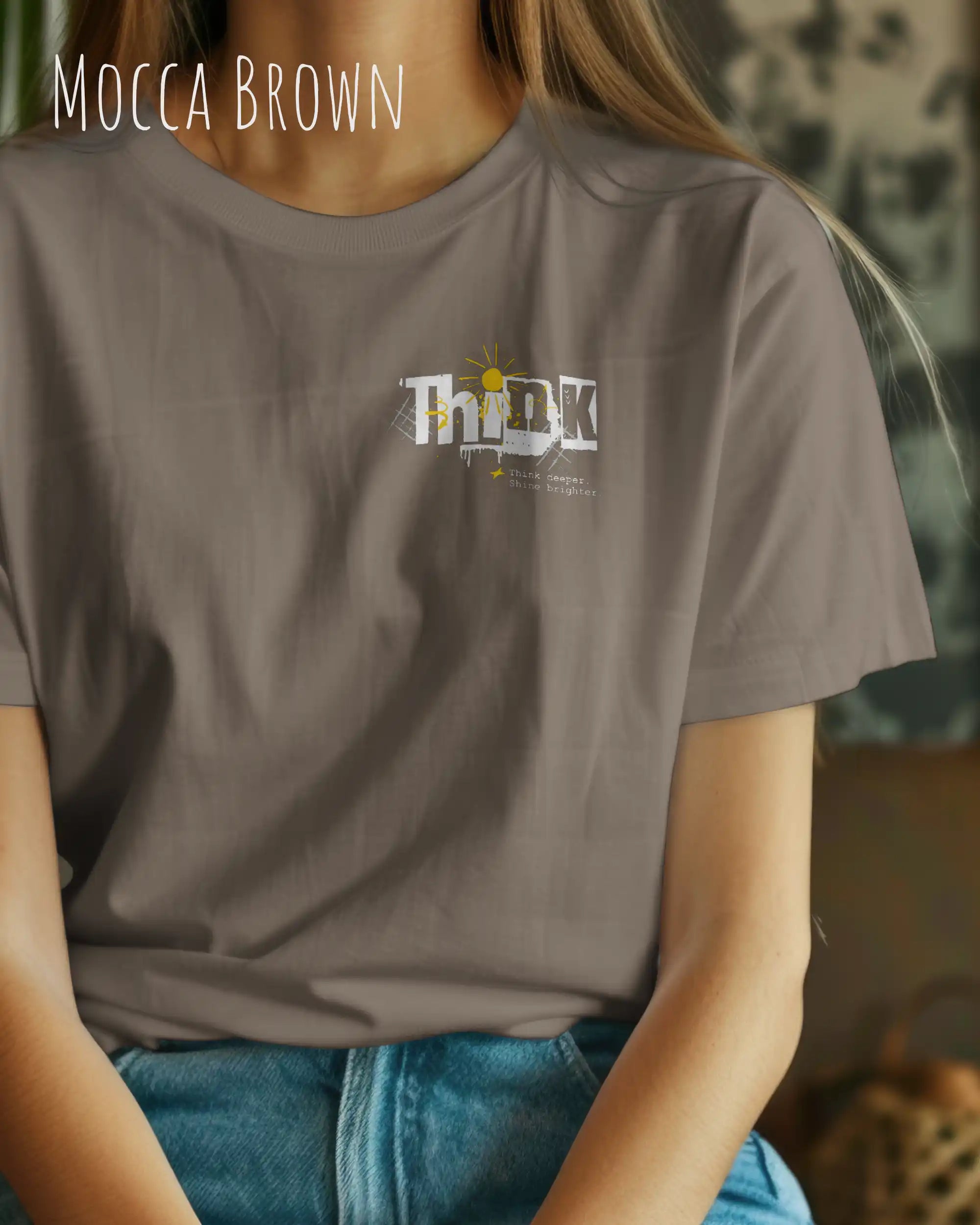 frau trägt leichtes sommer t shirt aus baumwolle in farbe Mocca brown mit think motiv alinks oben auf der brust