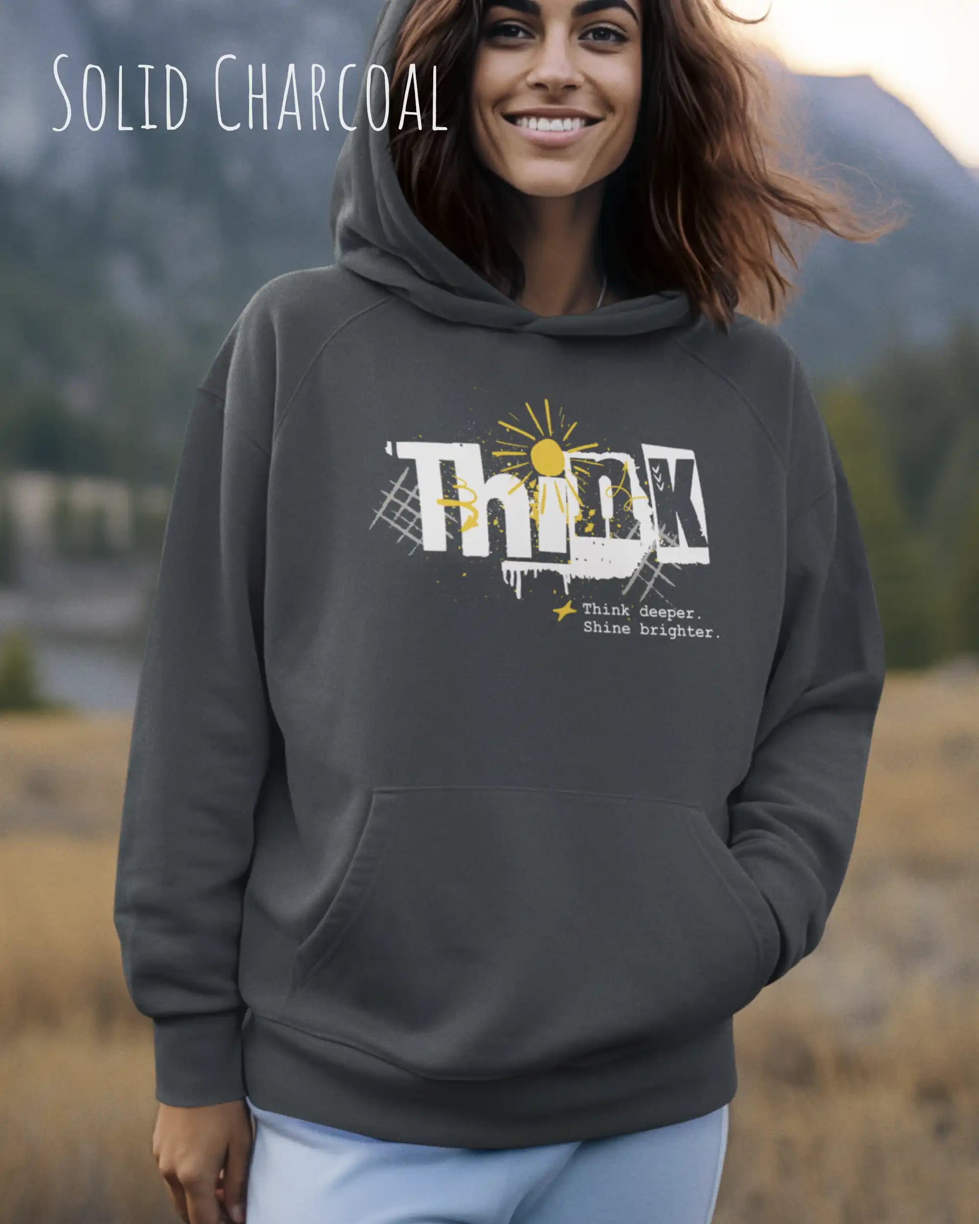 frau trägt streetwear hoodie im oversize fit in farbe charcoal mit think motiv auf der Brust