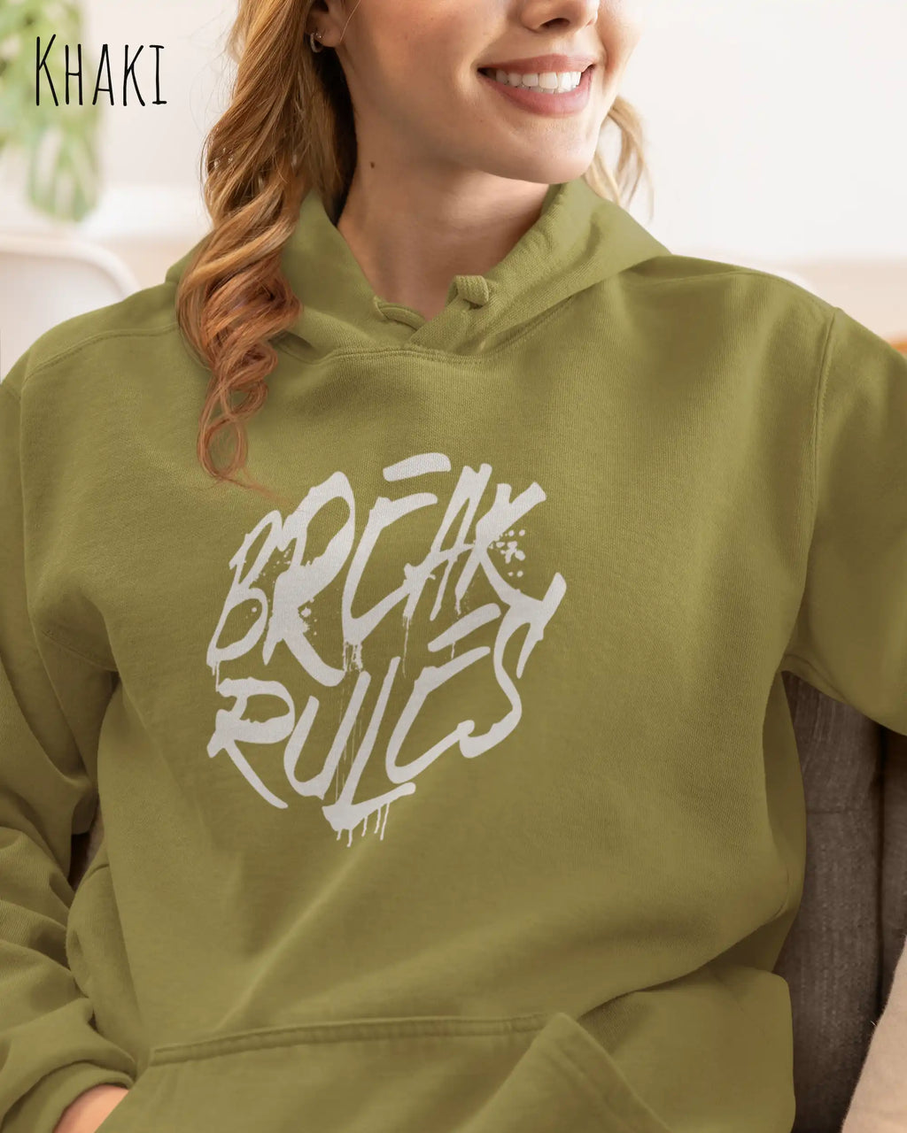 frau trägt basic hoodie aus weicher baumwollmischung in farbe khaki mit break rules motiv auf der Brust