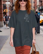 frau trögt ein oversized heavyweight design-t-shirt in der farbe charcoal und mit dem motiv keep it simple links oben