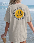 eine frau trägt ein oversized heavyweight t-shirt  in der farbe natural stone  mit dem backprint design nothing beats a great smile today.
