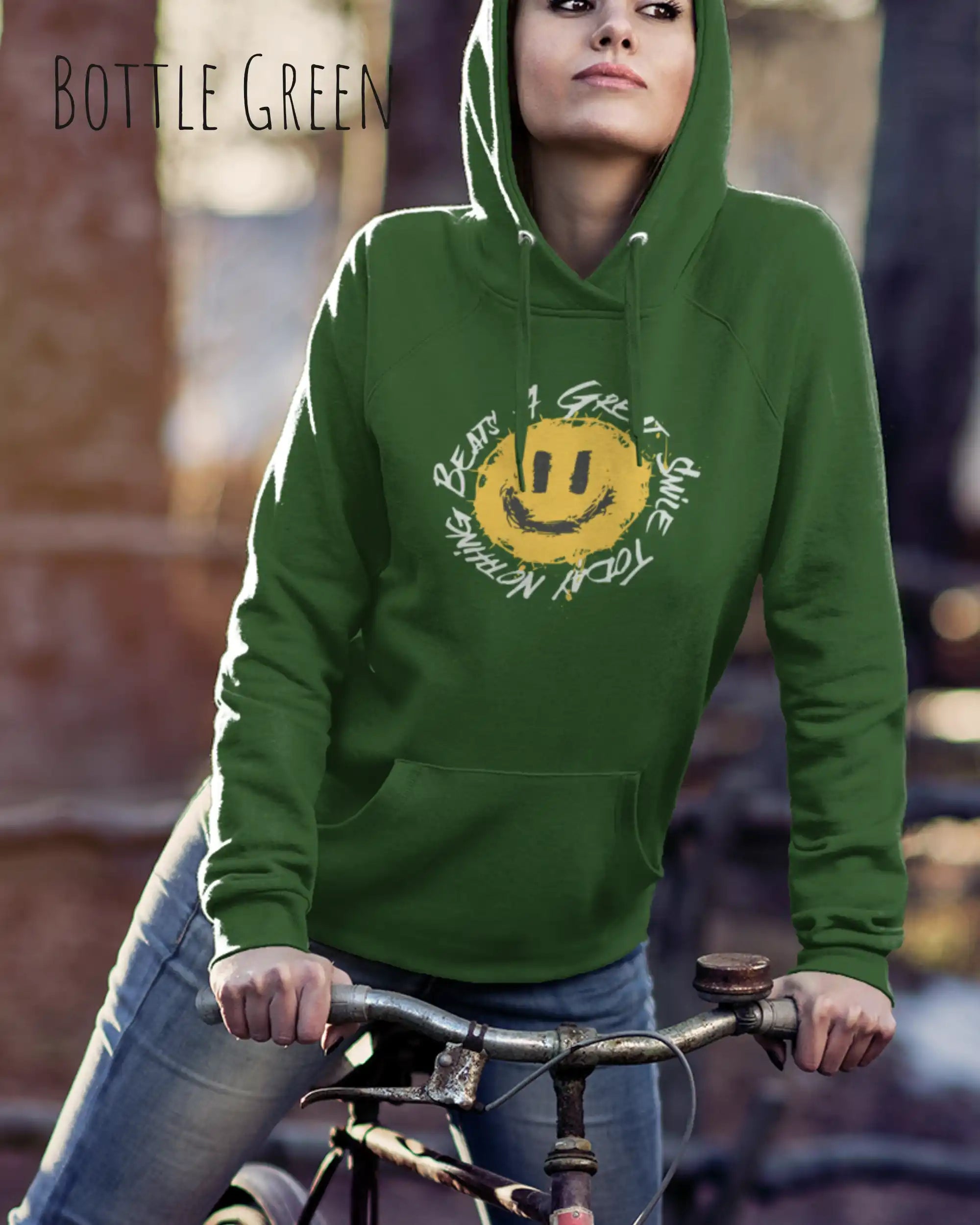 Das Bild zeigt eine frau, die einen einen femininen Hoodie in bottle green mit dem Design nothing beats a great smile trägt.