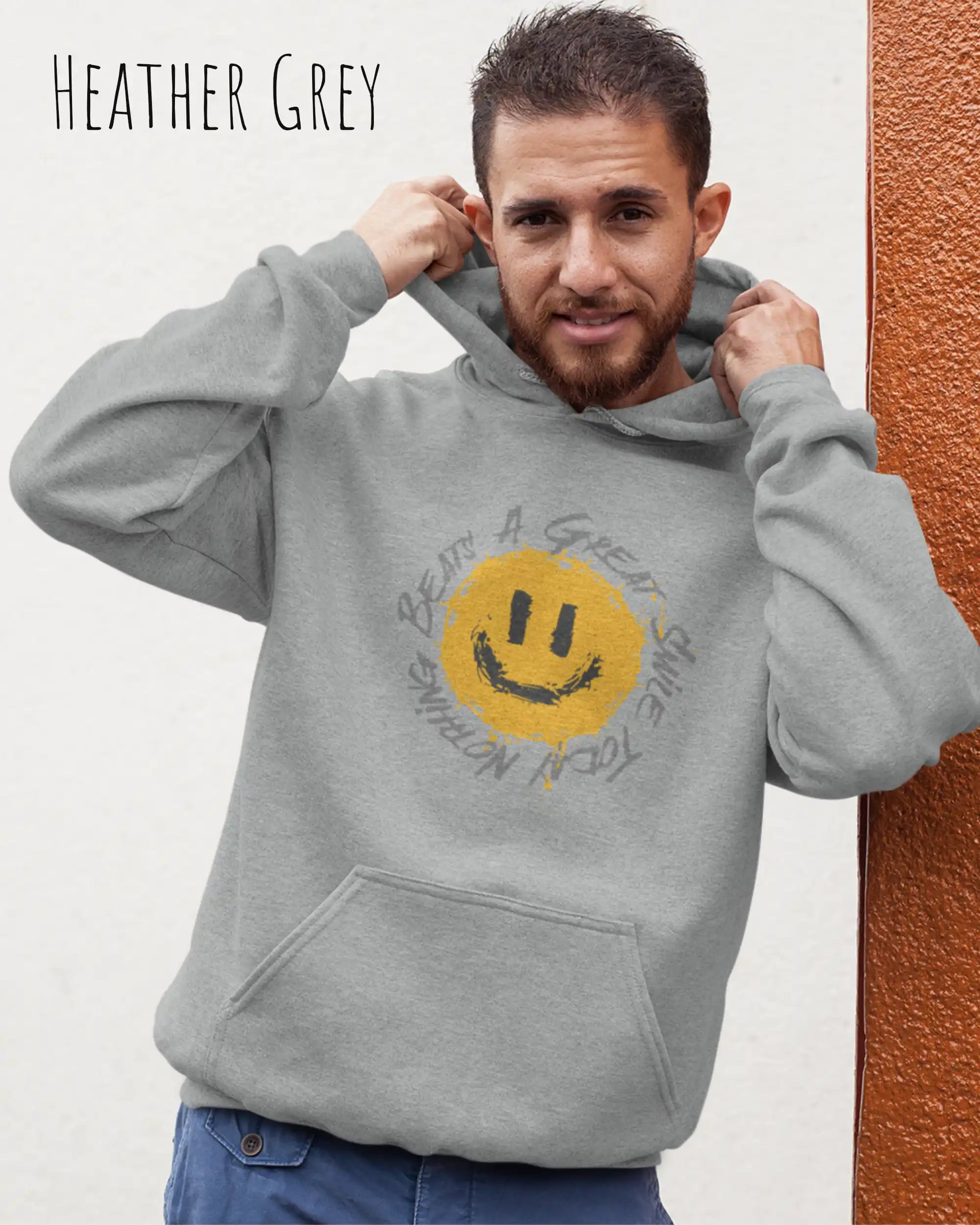 Das Bild zeigt einen mann, der einen  oversized Grafik hoodie in der farbe heather grey  mit dem design notihing beats a great smile trägt.