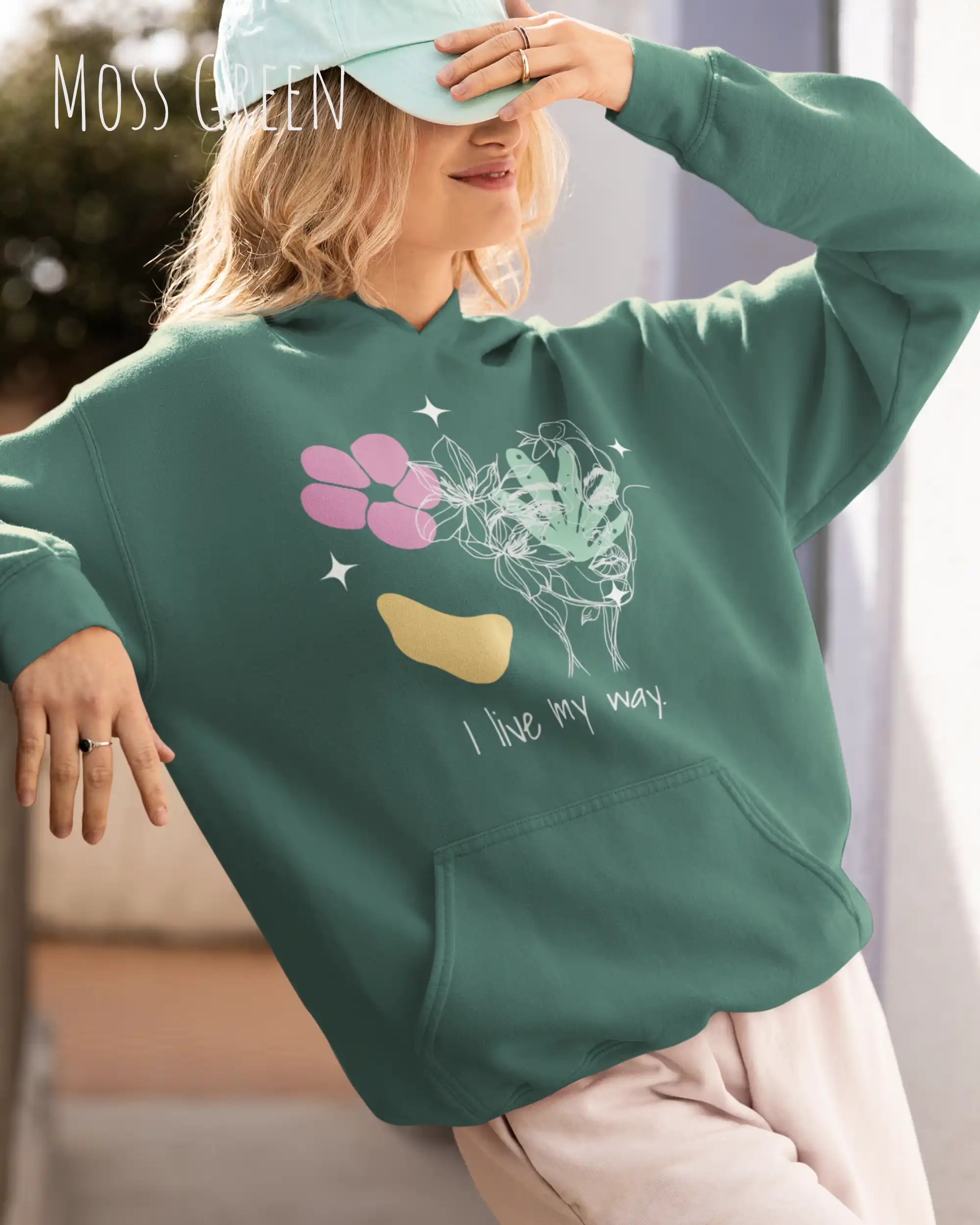 Frau trägt einen Oversized Design-Hoodie 
in der Farbe MOSS GREEN mit dem Statement I LIVE MY WAY.