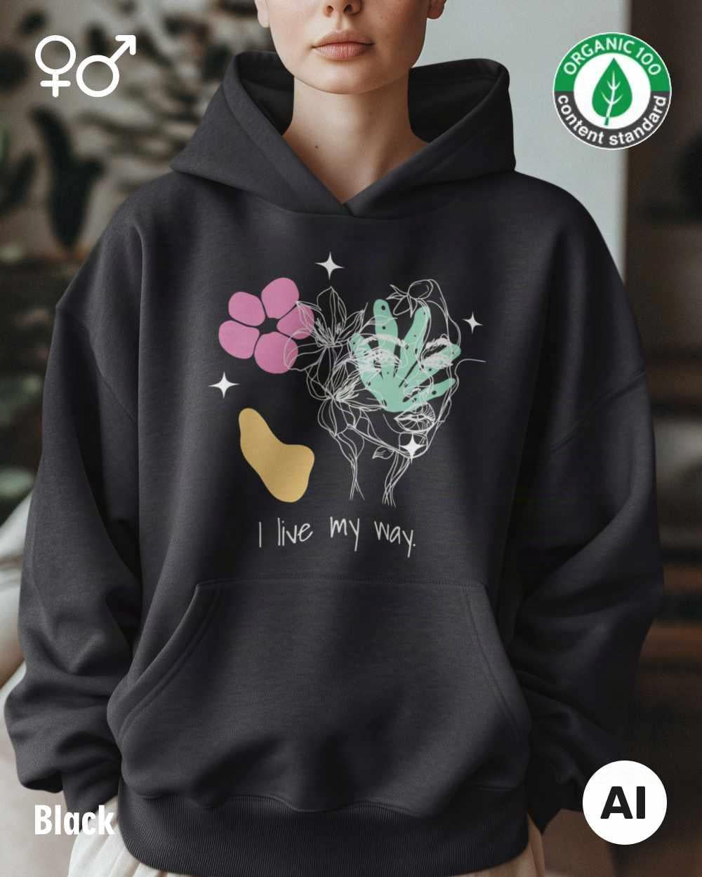 eine frau trägt einen Premium Design-Hoodie aus 100% Bio-Baumwolle in der farbe black mit dem motiv "i live my way" vorne mittig auf der brust.