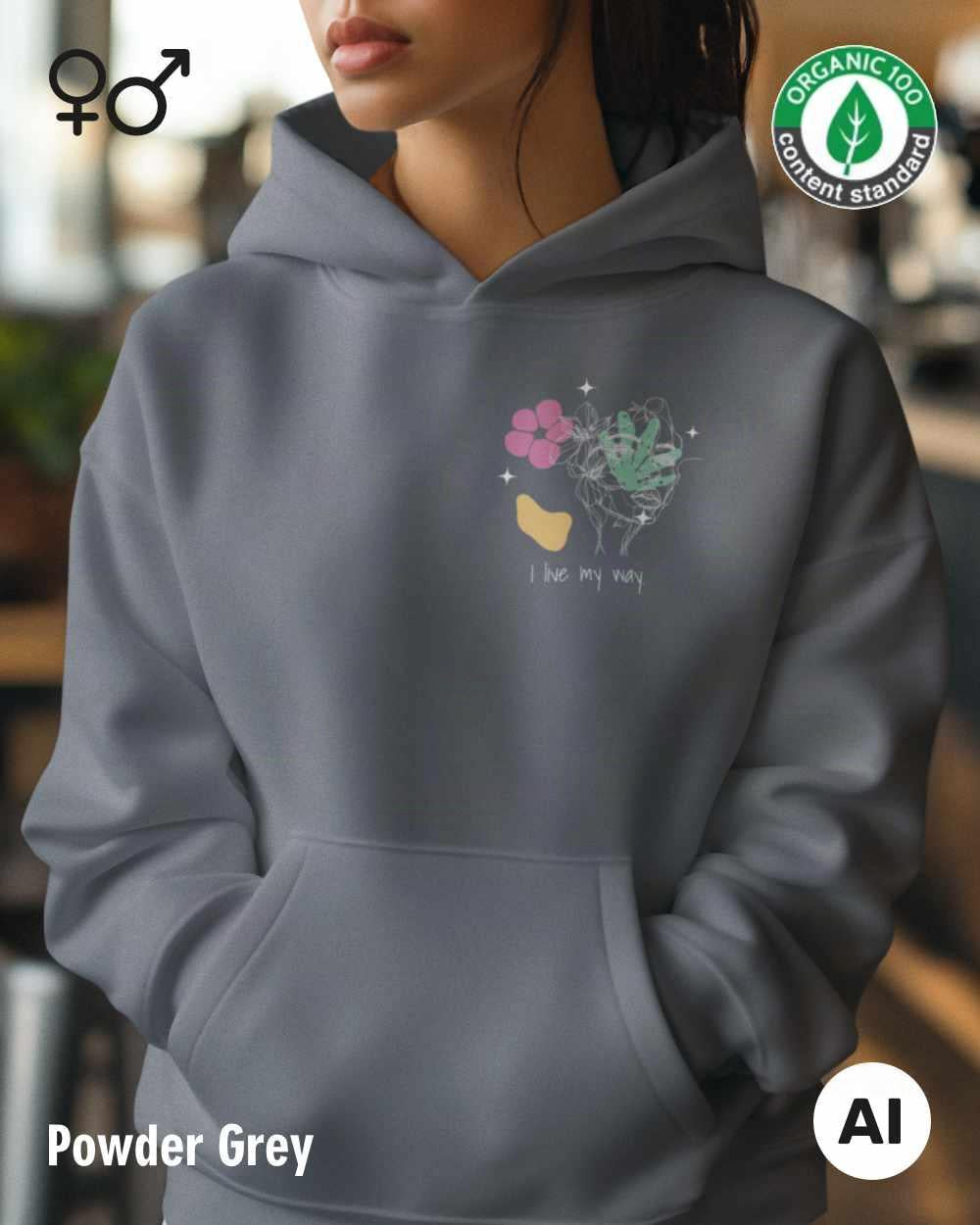 eine frau trägt einen Premium Design-Hoodie aus 100% Bio-Baumwolle in der farbe powder grey mit dem motiv "i live my way" oben links.