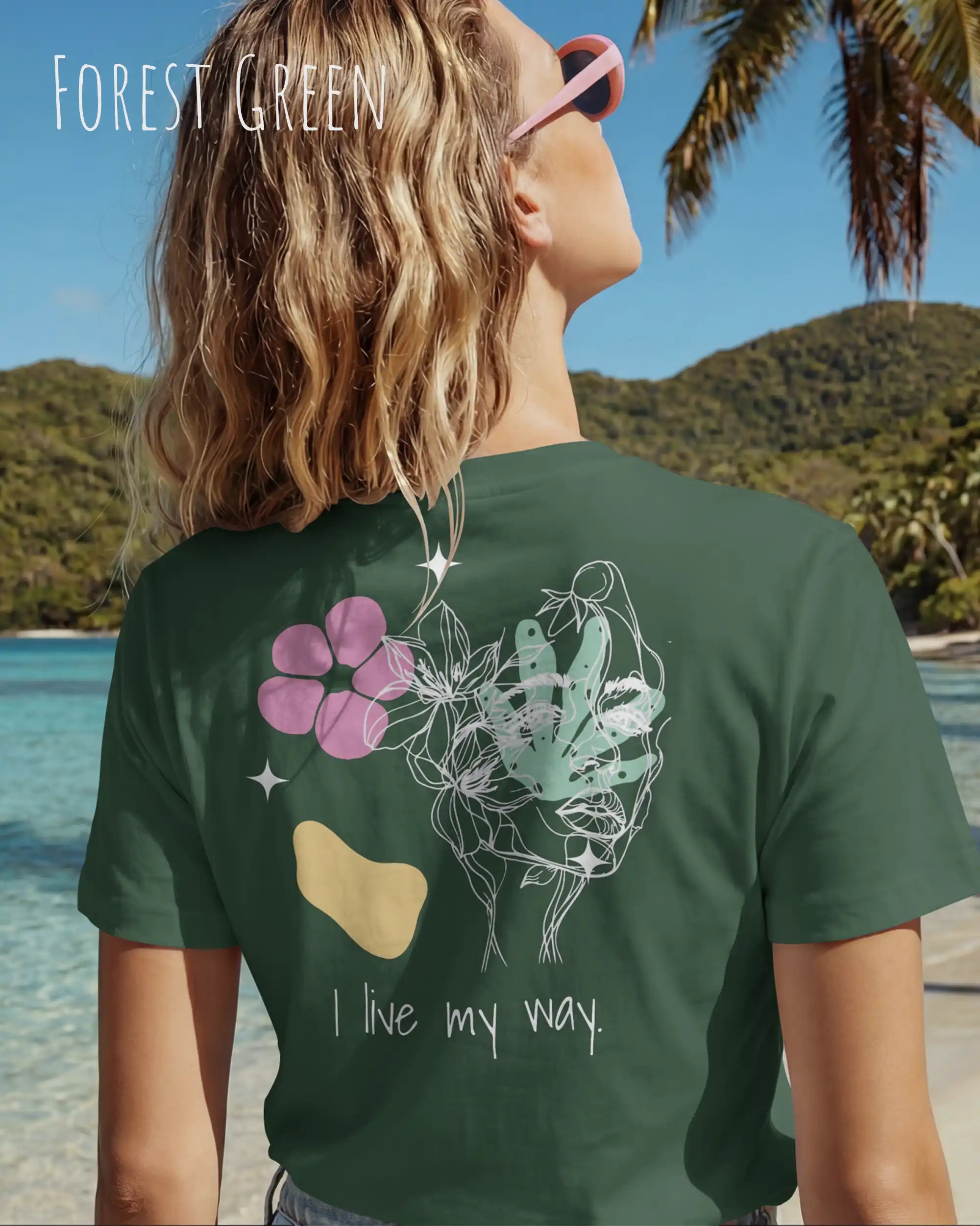 Eine Frau trägt ein Bio Design-T‑Shirt mit femininen Schnitt in der Farbe Forest Green und dem Statement I live my way auf dem Rücken.