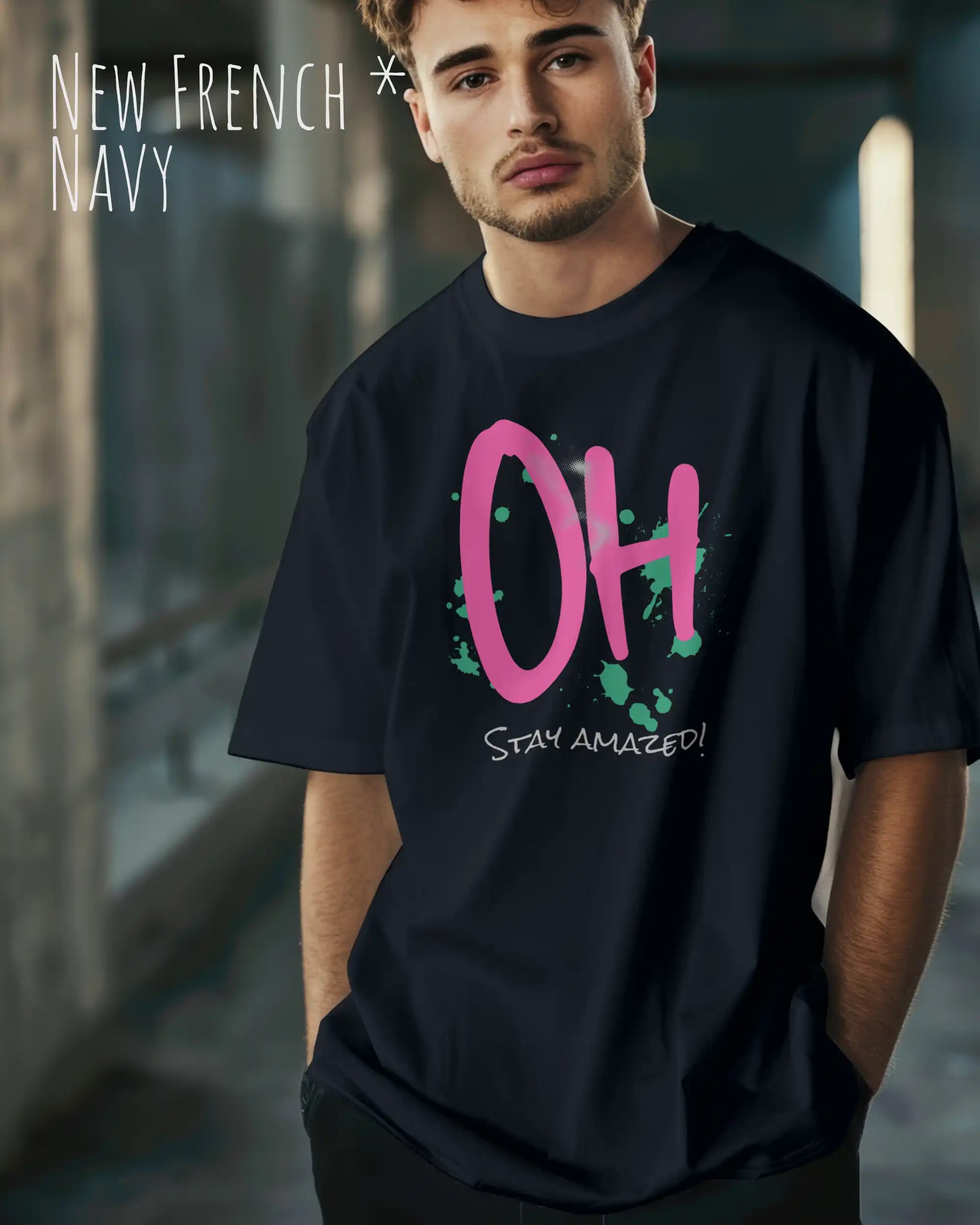 Mann trägt das Heavyweight Oversized T-Shirt AWDis 240 T in der Farbe new french navy mit dem Design OH STAY AMAZED auf der Brust.