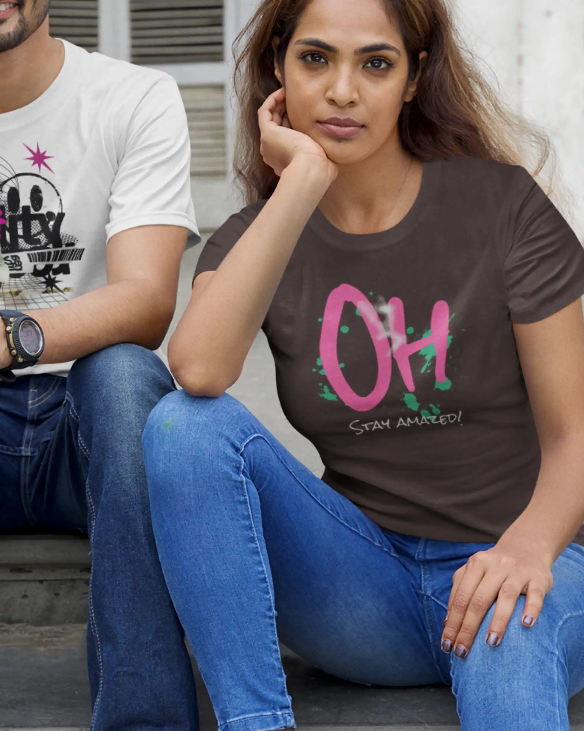 das bild zeigt eine junge frau, die ein design-t-shirt in der farbe chocolate mit dem motiv stay amazed trägt.