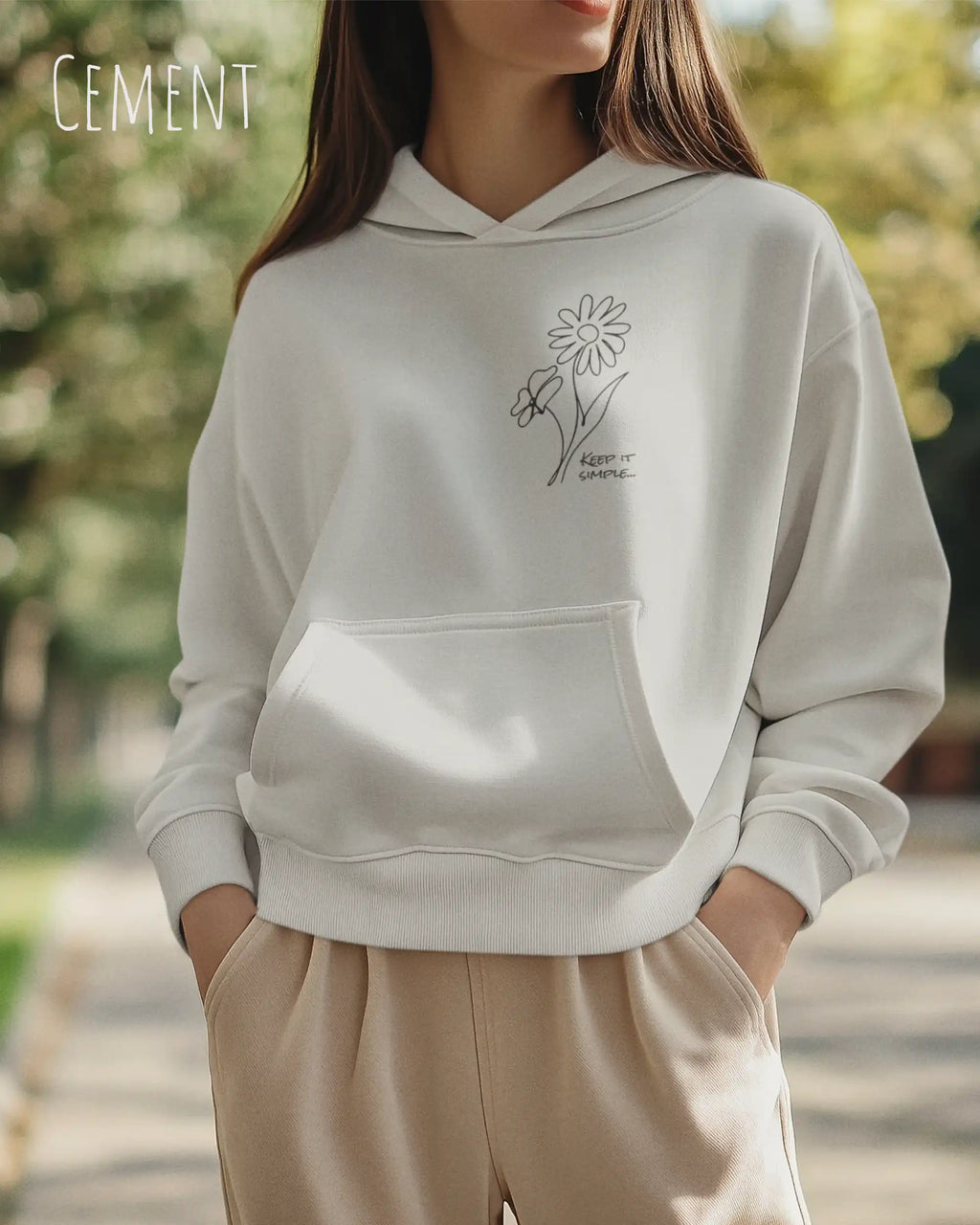 Frau trägt einen heavyweight oversized hoodie in der farbe cement mit dem minimaoistischen Design keep it simple.
