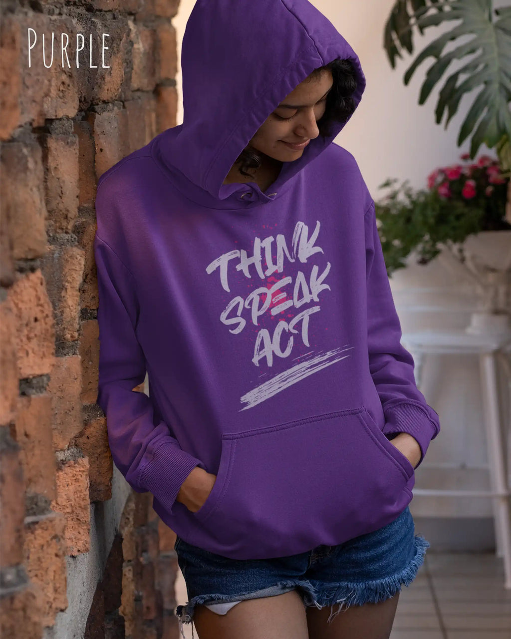 Eine Frau trägt den damen design hoodie JH001F von awdis in der Farbe purple mit dem STATEMENT Design THINK SPEAK ACT