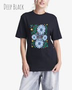 Das Bild zeigt eine Frau, die ein Design-T-Shirt in der farbe deep black  aus atmungsaktiver Baumwolle  mit dem statement WILD AND FREE trägt.
