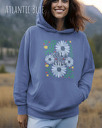 Eine Frau trägt einen Oversized Design-Hoodie in atlantic blue  mit dem Statement wild and free,