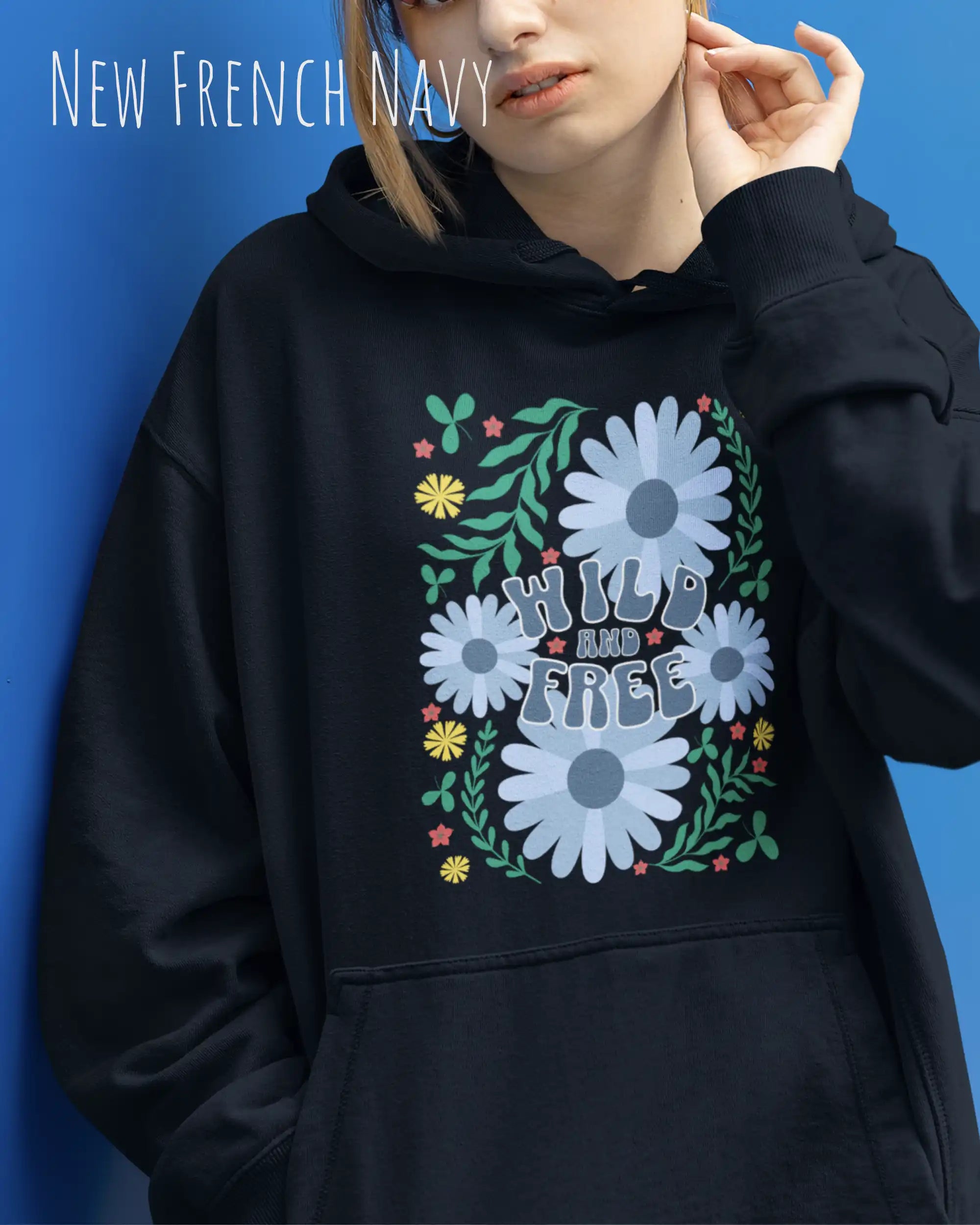 Eine Frau trägt einen Oversized Design-Hoodie in new French navy mit dem Backprint-Statement wild and free,