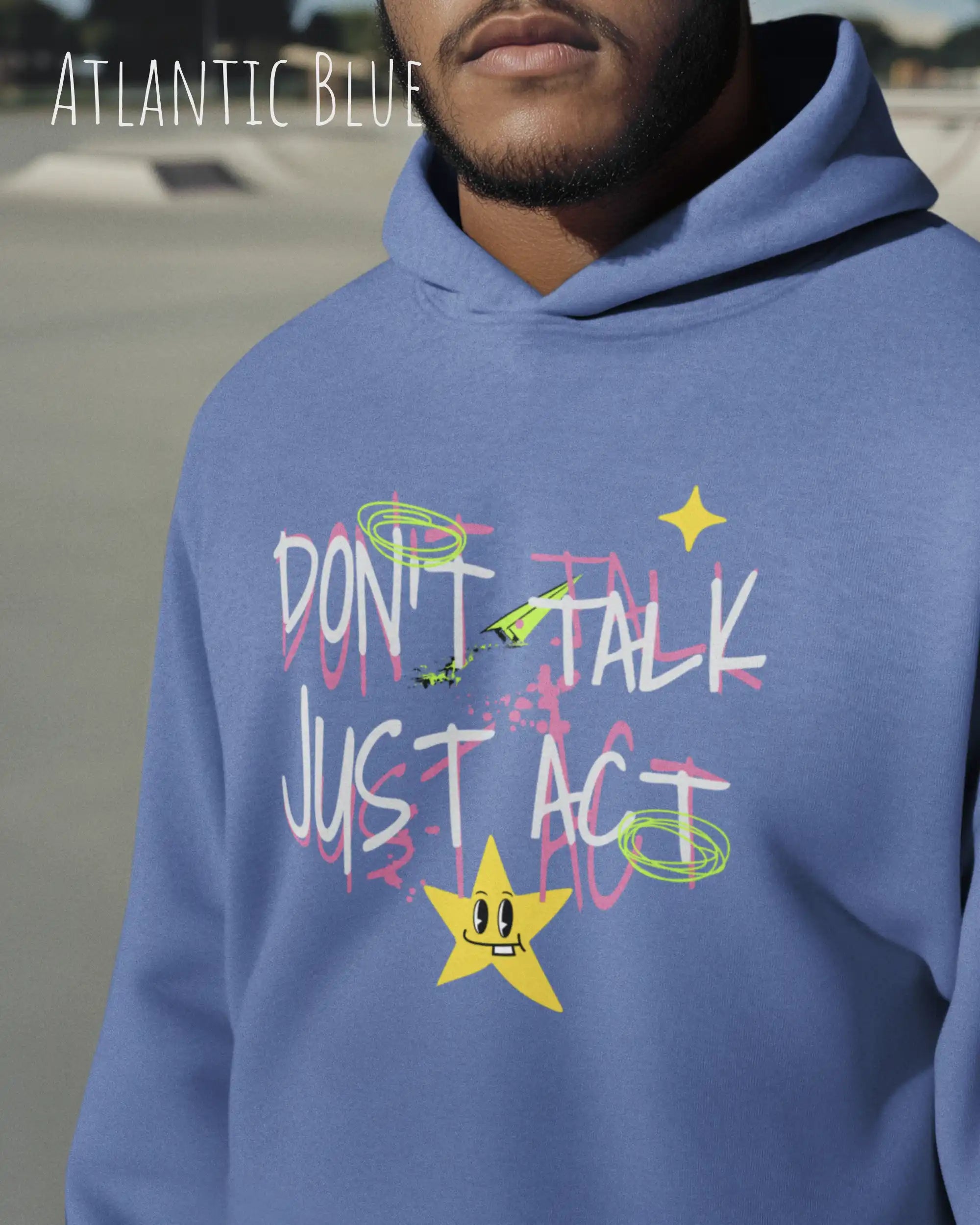 Ein Mann trägt einen oversized design hoodie in der farbe Atlantic blue mit dem statement don't talk just act.