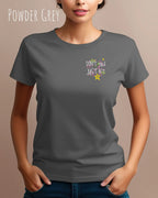 das bild zeigt eine frau, die ein feminines Design-T-Shirt in der farbe powder grey mit dem design "Don't talk Just Act" oben links trägt.