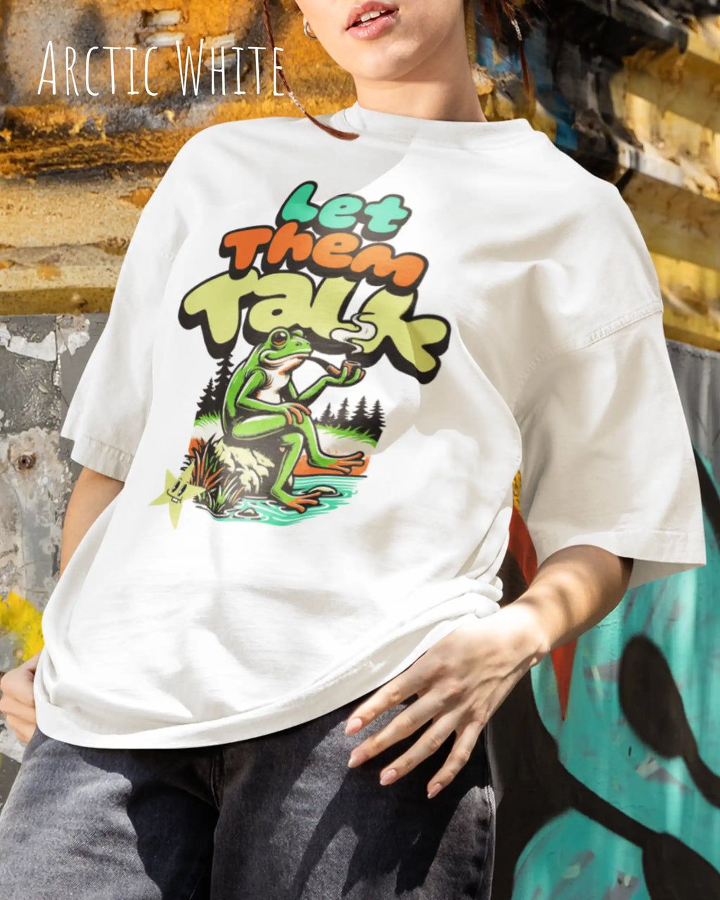 junge frau trägt ein oversized heavyweight design-t-shirt in der farbe arctic white mit dem entspannten streetwear-motiv let them talk - lass sie reden. 
