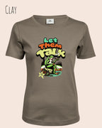 das bild zeigt das T-Shirt Tee Jays Women's Interlock Tee STYLE 580 in der farbe clay mit dem humorvollen design "LET THEM TALK".