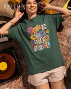 Junge frau trögt ein  heavywight oversized t-shirt  in der farbe moss green  mit dem design smile it confuses people.