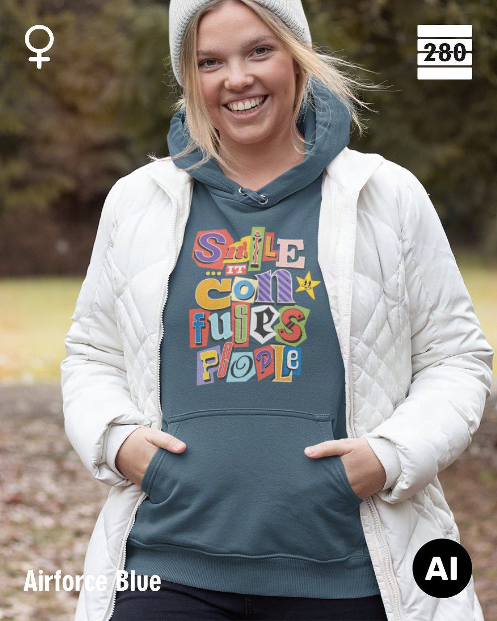 das bild zeigt eine frau, die einen leicht taillierten damen design hoodie in der farbe airforce blue und mit dem farbenfrohen motiv "smile ... it confuses people" trägt