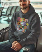 ein mann trägt einen Oversized Design-Hoodie in  charcoal mit der farbenfrohen grafik "Smile ... it confuses people".