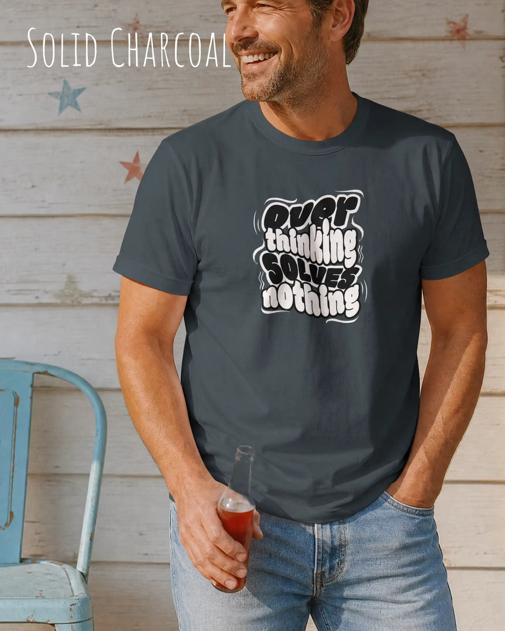 mann trögt ein design.t-shirt in solid charcoal mit dem motiv overthinking solves nothing.