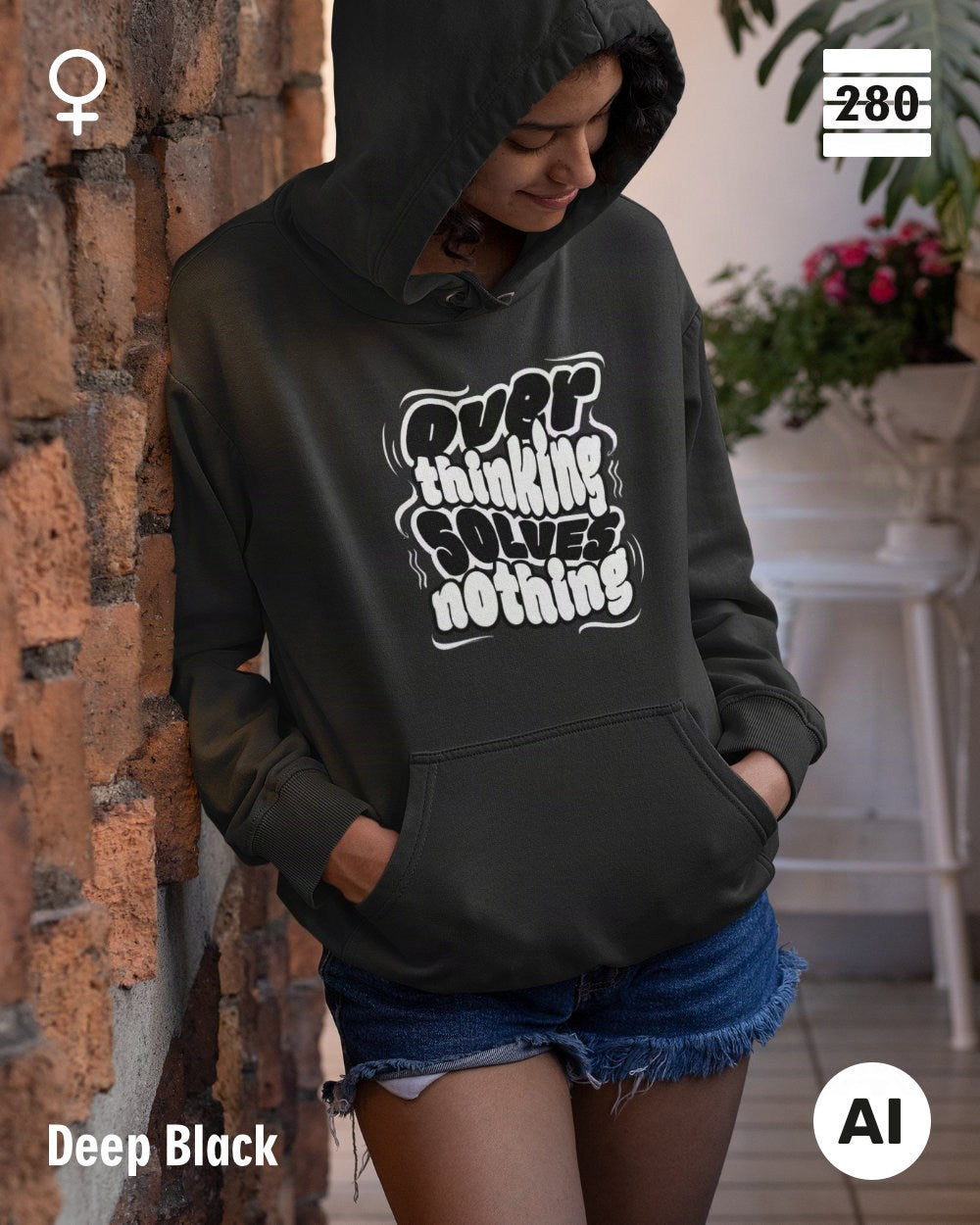 das bild zeigt eine frau, die einen statement hoodie in der farbe deep black und mit dem motiv "overthinking solves nothing" trägt.
