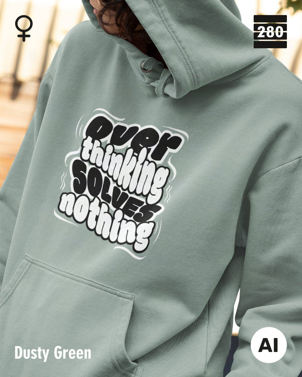 das bild zeigt eine frau, die einen statement hoodie in der farbe dusty green und mit dem motiv "overthinking solves nothing" trägt.