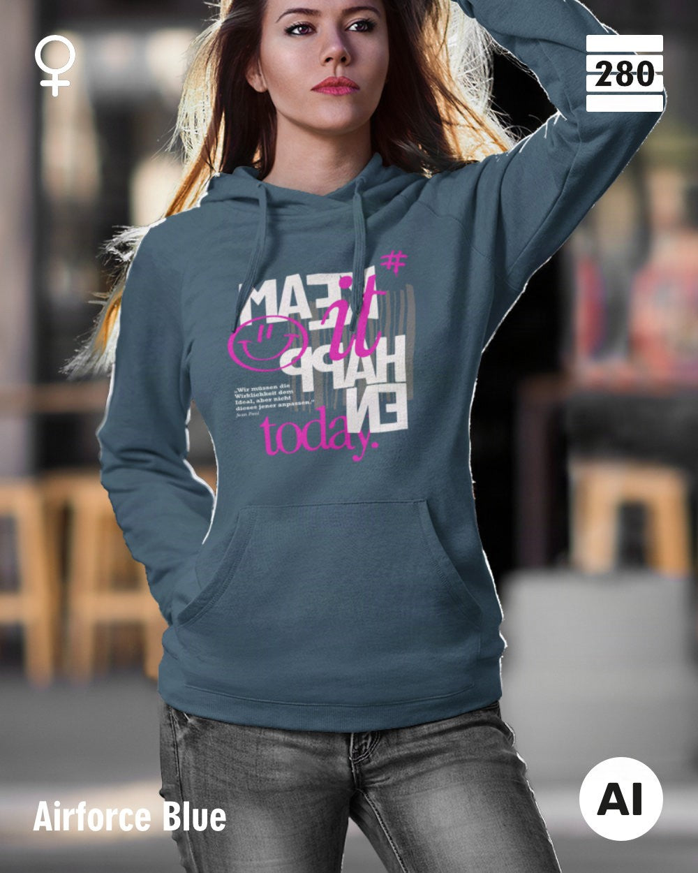 das bild zeigt eine junge frau, die einen leicht taillierten damen hoodie in der farbe airforce blueund mit dem statement design "make it happen today" trägt.