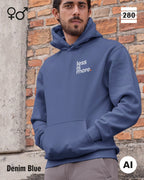 das bild zeigt einen mann, der einen unisex design hoodie in der farbe denim blue und mit dem minimalistischen motiv "less is more" trägt.