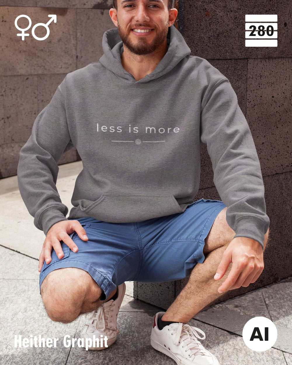 das bild zeigt einen mann in der hocke, der einen unisex design hoodie in der farbe heather graphit und mit dem zeitlosen motiv "less is more" trägt.