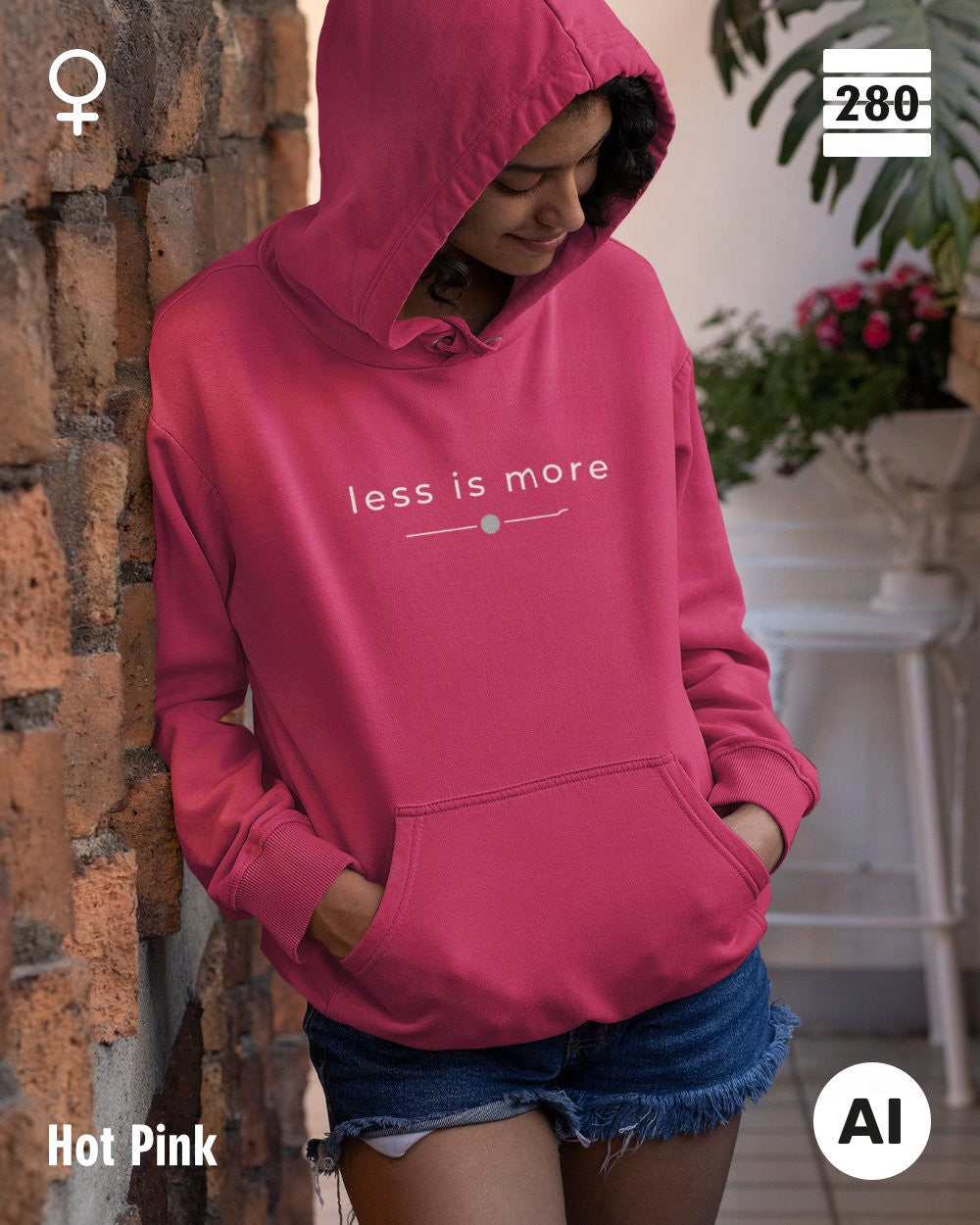 das bild zeigt eine frau, die einen leicht taillierten damen kapuzenpulli  in der farbe hot pink und mit dem zeitlosen design "less is more" trägt.